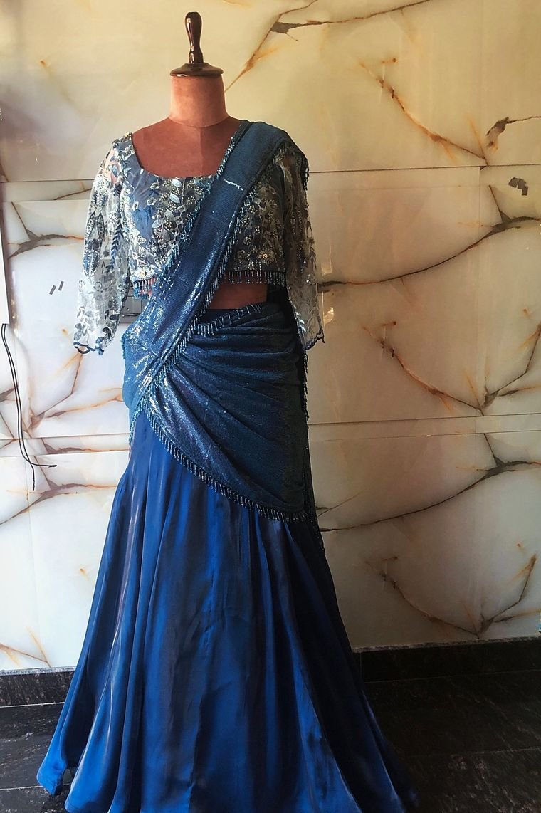Teal pre-draped lehenga saree with sequin drape and embroidered tulle blouse on a mannequin at Karishma&rsquo;s Closet